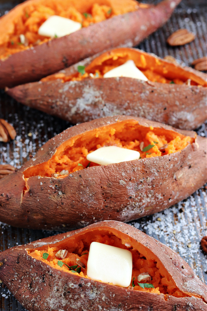 smoked sweet potatoes on pan with butter and parsley